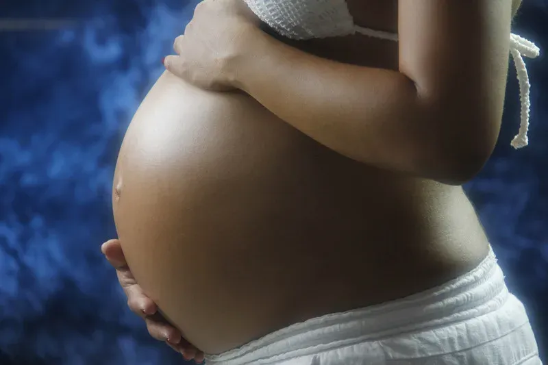 Femme enceinte tenant son ventre à deux mains